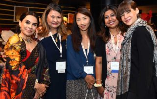 Photo of five female attendees of the 2019 IWEC Conference looking at camera.